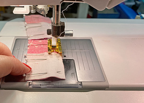 Chain piecing four-patches together, one right after the other without cutting the thread Chain piecing four-patches together, one right after the other without cutting the thread