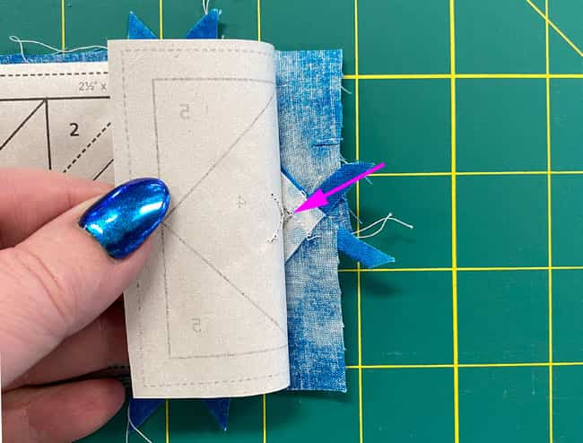 Pull the stitches away from the pattern so you can fold it back on the line