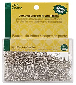 Curved safety pins are used in layering and basting a quilt