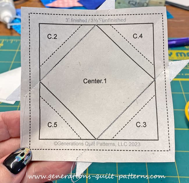 After sewing the first seams you can see that the stitches start and end past the outside dashed square that surrounds the unit After sewing the first seams you can see that the stitches start and end past the outside dashed square that surrounds the unit