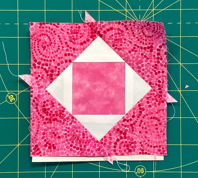 All the sewing is done for our Economy quilt block, all that's left to do is trim to size All the sewing is done for our Economy quilt block, all that's left to do is trim to size