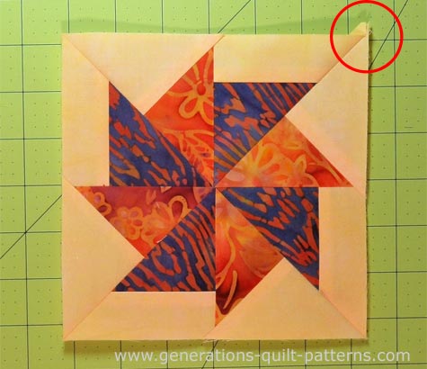 Finished Flying Kite quilt block with one dog ear left to trim