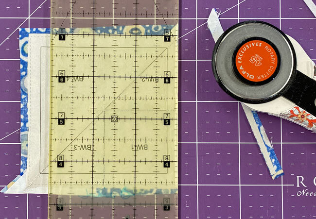 Trim away the excess past the 1/4" seam allowance Trim away the excess past the 1/4" seam allowance