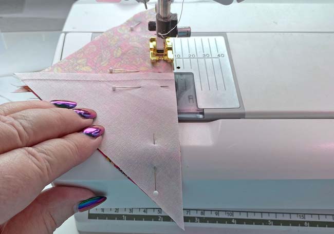 Sewing the two halves of the Quarter Square Triangle together Sewing the two halves of the Quarter Square Triangle together