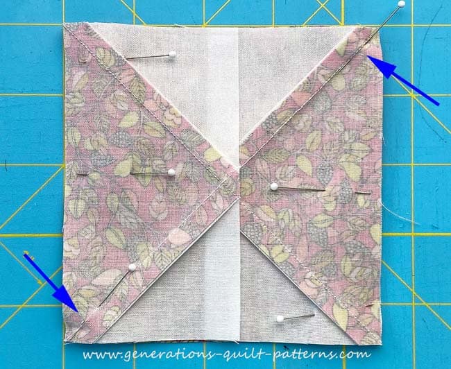 Pin a FG, point outward, to opposite light sides of the Quarter Square Triangle unit