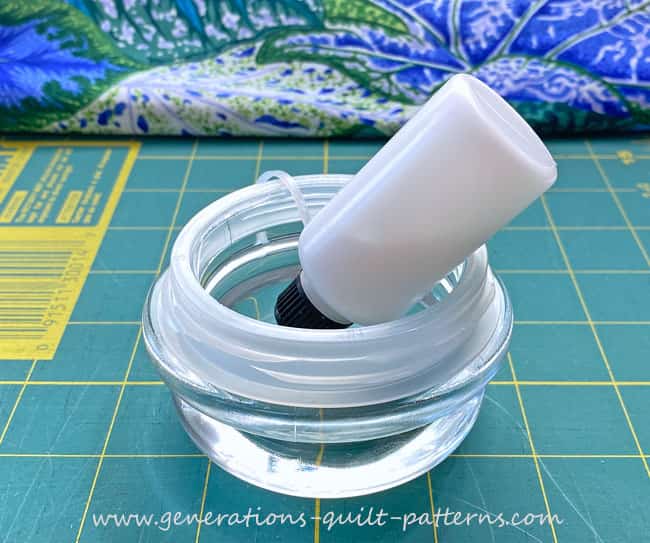 Put your fine-tipped bottle in a dish, point end down to keep glue at the tip and ready for more glue basting