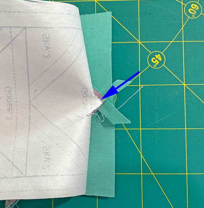 Pull the paper away from the stitches to get ready to trim to a 1/4" SA Pull the paper away from the stitches to get ready to trim to a 1/4" SA