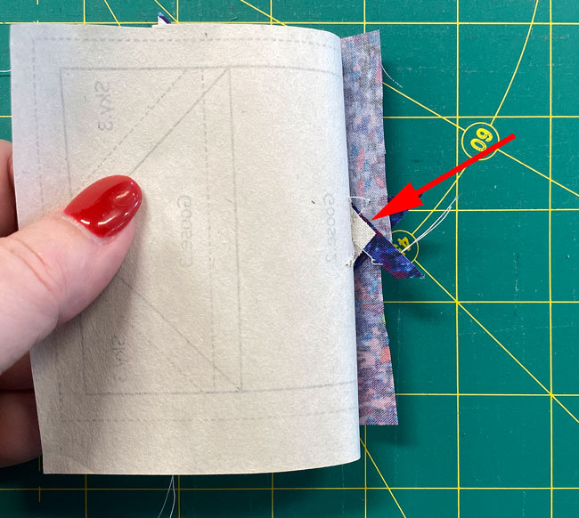 You'll need to pull the pattern away from your sewing to fold the pattern back on itself. You'll need to pull the pattern away from your sewing to fold the pattern back on itself.