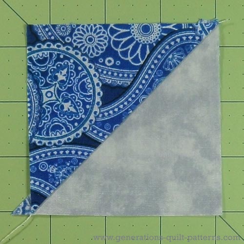 Half square triangle unit ready to trim the dog ear off Half square triangle unit ready to trim the dog ear off