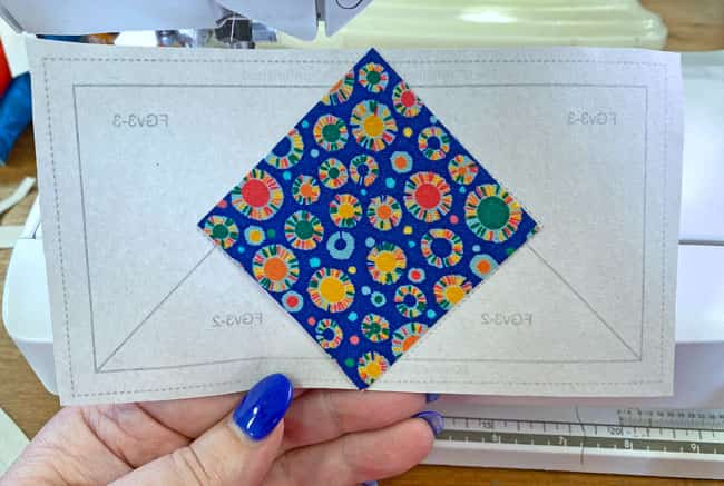 Position the FGv3-1 patch on the unprinted side of the paper piecing pattern Position the FGv3-1 patch on the unprinted side of the paper piecing pattern