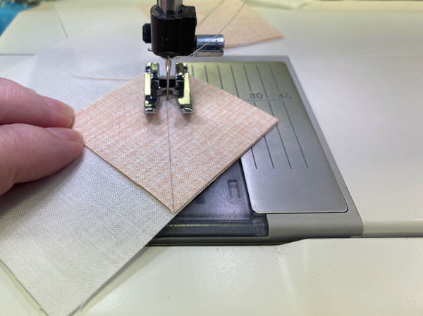 Sew on the drawn line to make the corner units Sew on the drawn line to make the corner units