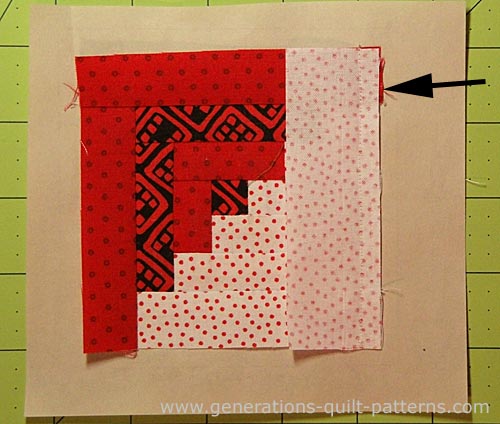 Trim away any excess dark fabric that shows past the seam allowance to prevent it from shadowing through