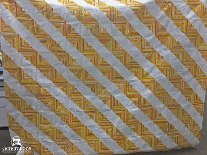 The finished yellow Log Cabin quilt top