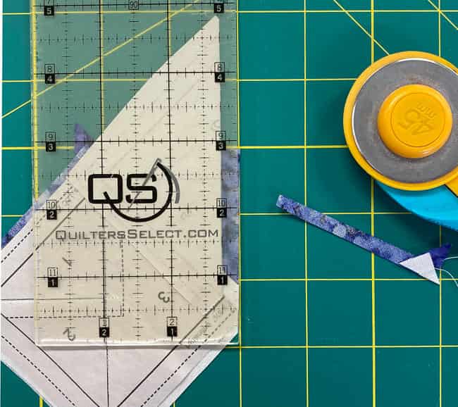 The 1/4" mark on the ruler is directly over the folded edge of the pattern, ready to trim down to a perfect 1/4" SA