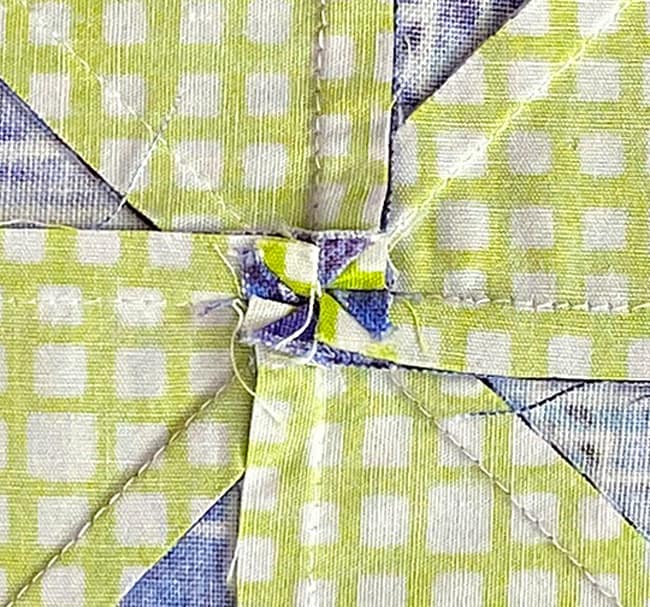 Closeup of the twirled seams in the very center of the block from the backside Closeup of the twirled seams in the very center of the block from the backside