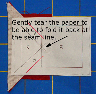 Pull the paper away from the seam allowance
