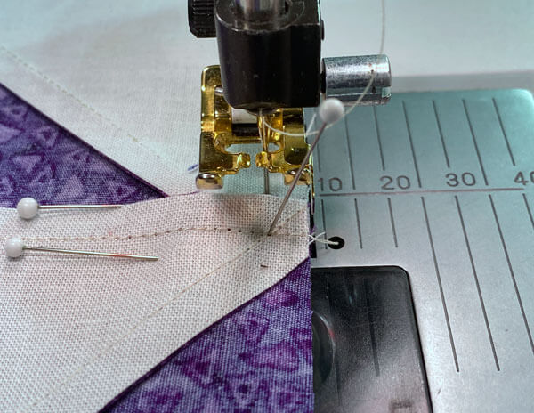 Raise your presser foot to set it down on top of the bulky center seam