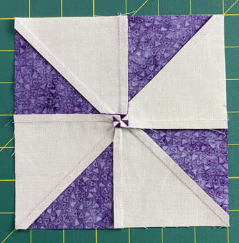 Pinwheel quilt block with the center seams twirled