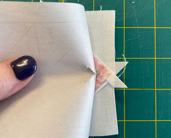 You need to pull the paper away from the stitches at the point before folding it back on itself You need to pull the paper away from the stitches at the point before folding it back on itself