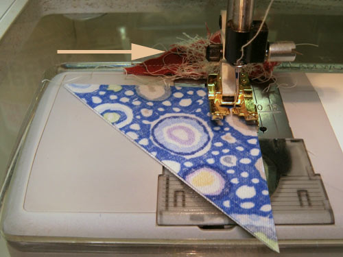 Sew two quarter square patches together, dark fabric on top