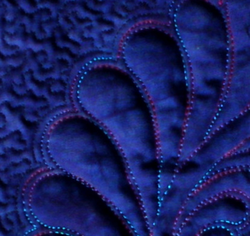 Feathers quilted with spaces between the elements