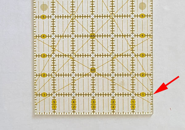 A square rotary cutting ruler with a 45&deg; line