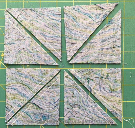 8 half square triangles ready for pressing and trimming