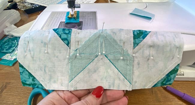 Pin the rows as needed to keep the patches aligned and edges even Pin the rows as needed to keep the patches aligned and edges even