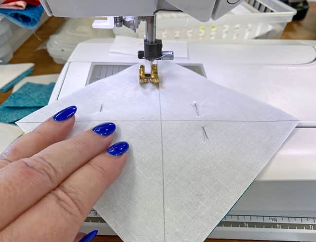 Sew a 1/4" away from both sides of both lines on the QST1 and QST2 squares