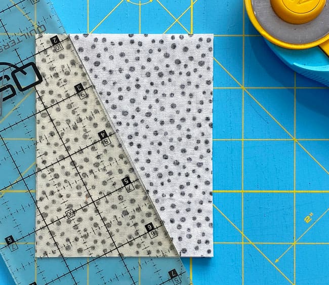 Line up your ruler with the marks at the edges and cut through all four layers Line up your ruler with the marks at the edges and cut through all four layers