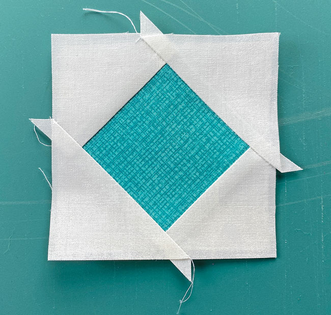 After paper piecing on freezer paper, this is the untrimmed Square in Square quilt block