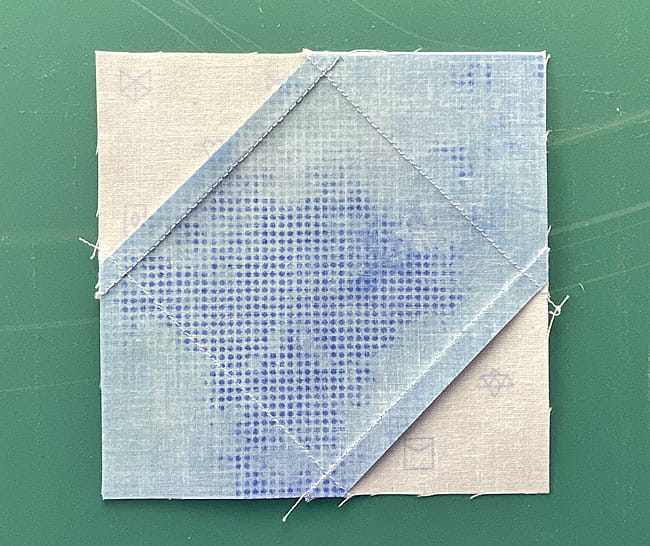 Finished square in a square block made with Folded corners from the backside