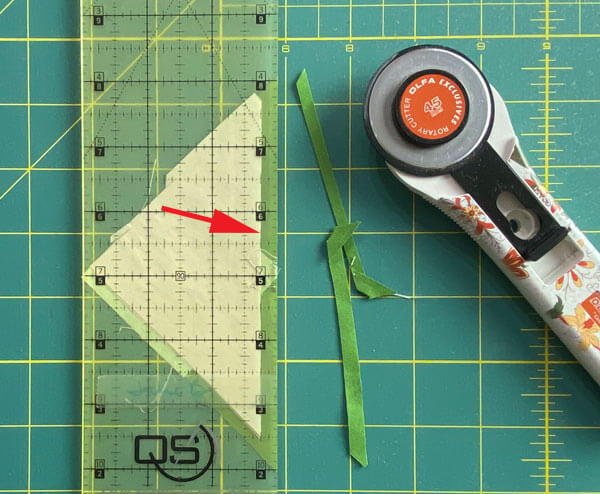 Use a ruler to fold that paper pattern back on itself on the line and trim away the excess Use a ruler to fold that paper pattern back on itself on the line and trim away the excess