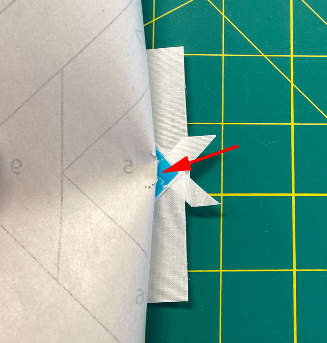 Pull back the paper from the stitches holding #1 and #2