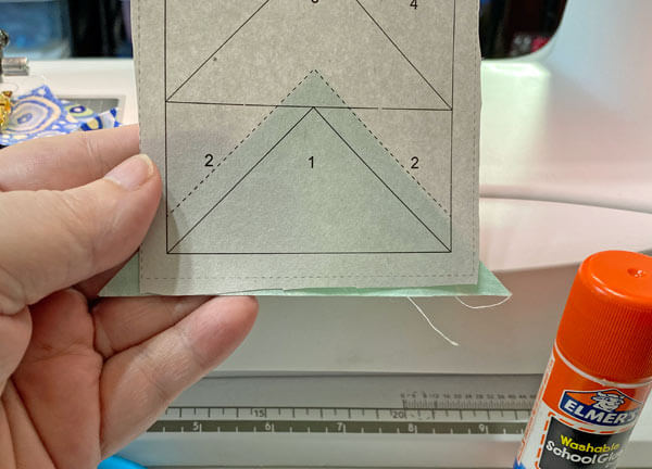 Position #1 on your Flying Geese pattern with a dot of Elmer's Washable Glue Stick