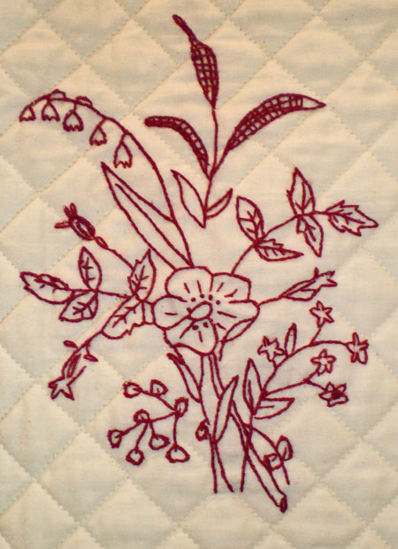 Hand embroidery with machine quilted grid quilting