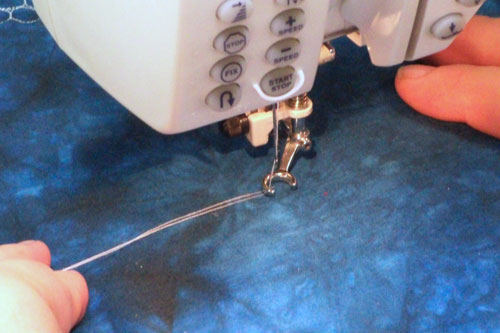 Bobbin and needle thread on the top side of the quilt sandwich