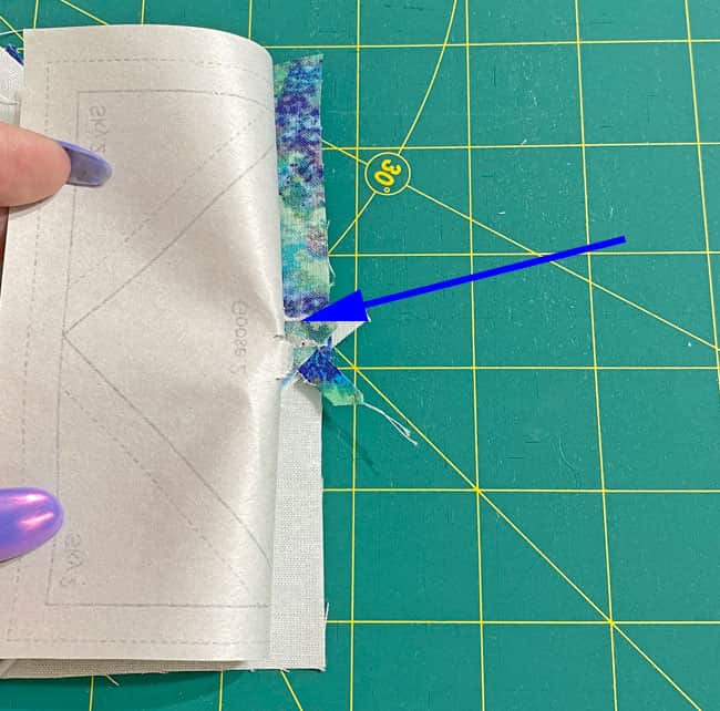 Pull the stitches in the center away from the paper pattern Pull the stitches in the center away from the paper pattern