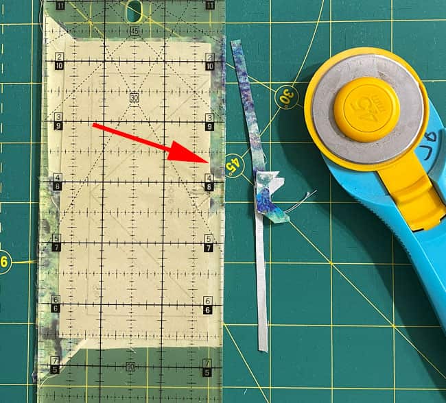 Trim away the excess fabric to leave behind a 1/4" seam allowance Trim away the excess fabric to leave behind a 1/4" seam allowance