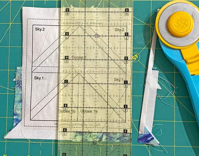Trimming the first side of a Yankee Puzzle unit Trimming the first side of a Yankee Puzzle unit